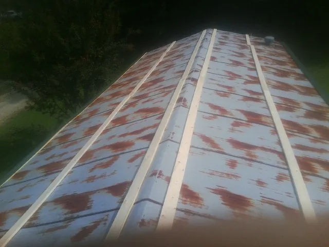 Rusted metal roof panels with new wood purlins before replacement — Storm Damage Roof Repair in Bent Mountain by Roofing Brothers